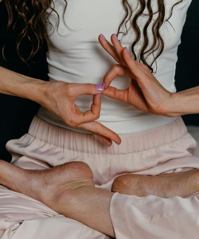 Close-up of a person's hands in a yoga mudra.